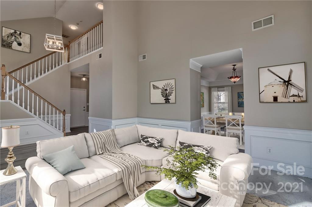 4821 Brownes Ferry Road Charlotte, NC 28269 - Photo 14 of 37 a living room with furniture and a chandelier