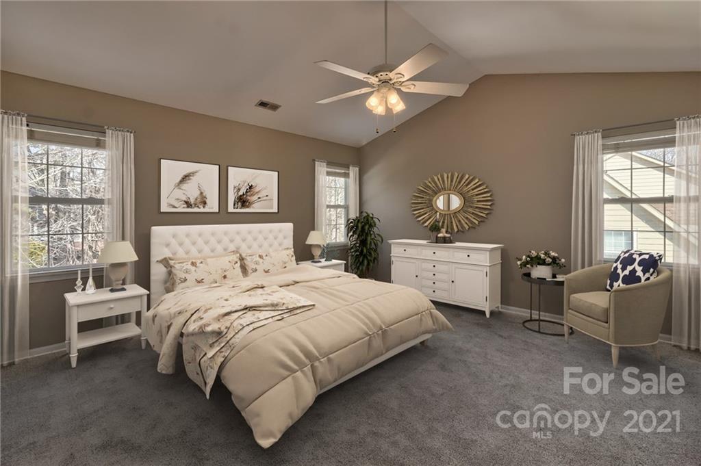 4821 Brownes Ferry Road Charlotte, NC 28269 - Photo 16 of 37 a bedroom with a bed and furniture