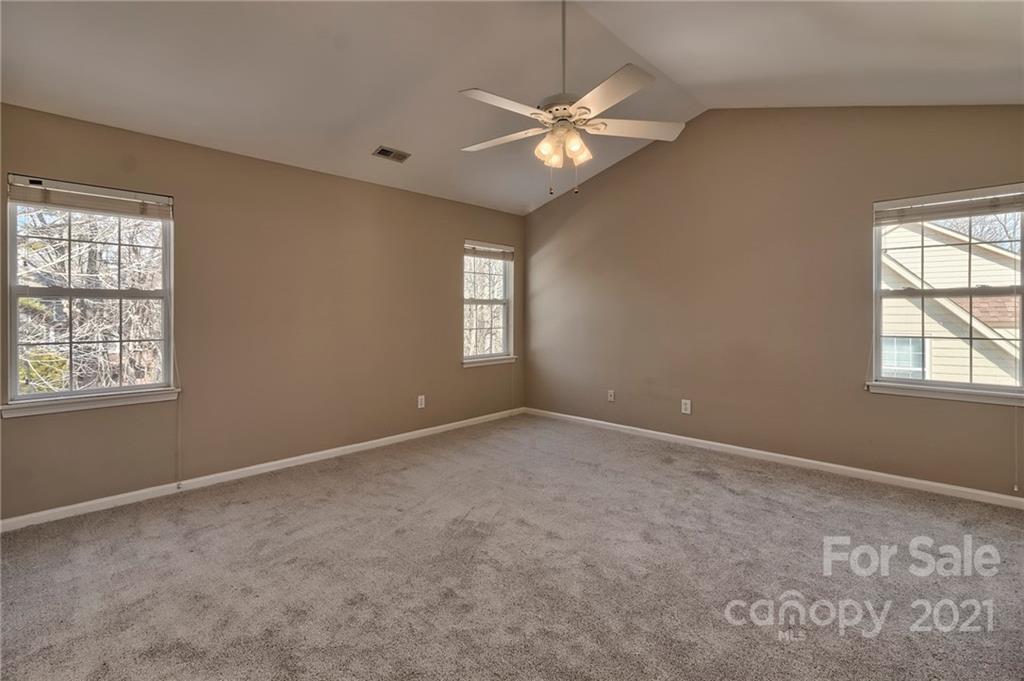 4821 Brownes Ferry Road Charlotte, NC 28269 - Photo 17 of 37 an empty room with windows and fan