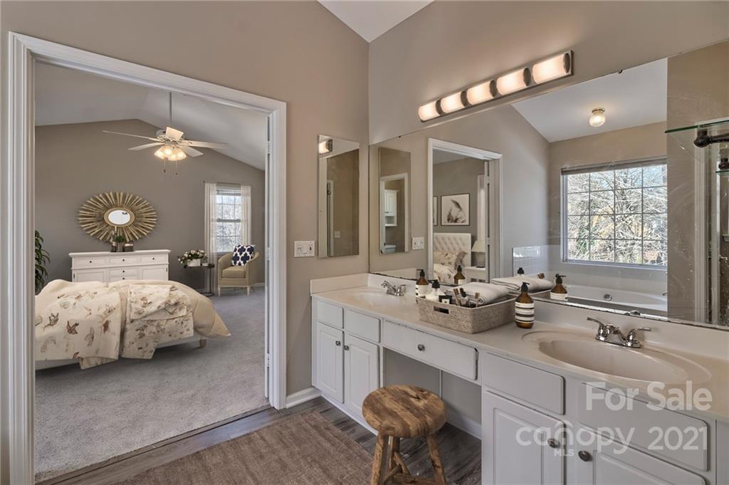 4821 Brownes Ferry Road Charlotte, NC 28269 - Photo 18 of 37 a en suite bathroom with sink and mirror