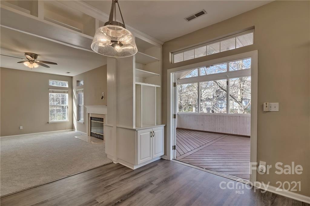 4821 Brownes Ferry Road Charlotte, NC 28269 - Photo 22 of 37 a view of a room with wooden floor a ceiling fan and windows