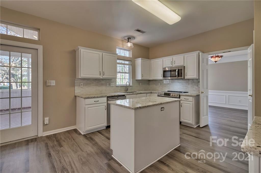 4821 Brownes Ferry Road Charlotte, NC 28269 - Photo 23 of 37 a kitchen with a sink cabinets stainless steel appliances and a window