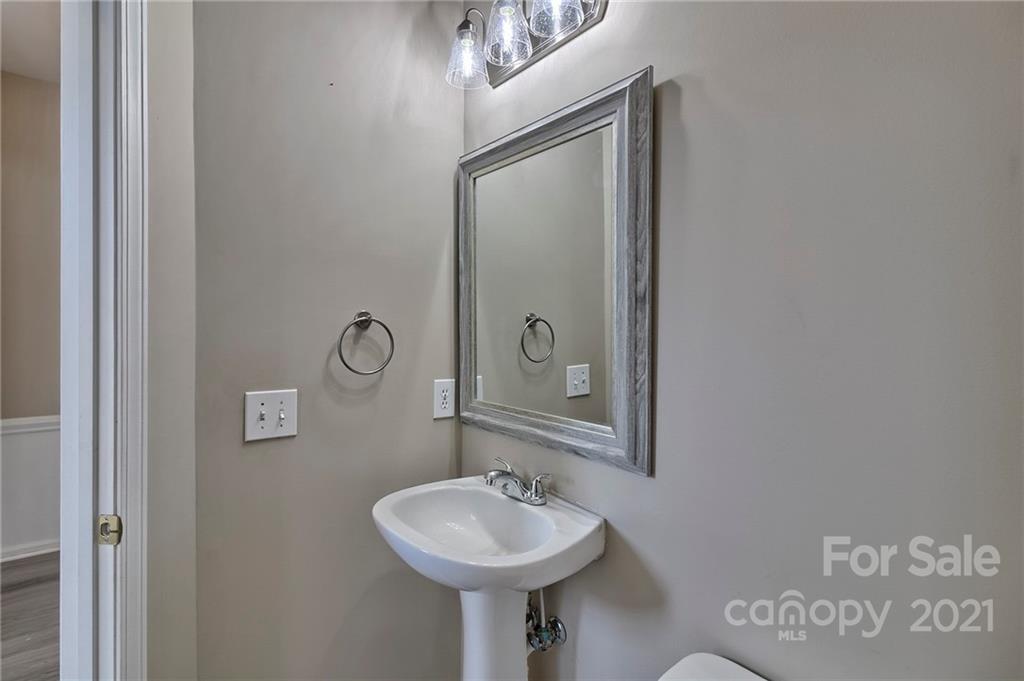 4821 Brownes Ferry Road Charlotte, NC 28269 - Photo 26 of 37 a bathroom with a sink and a mirror