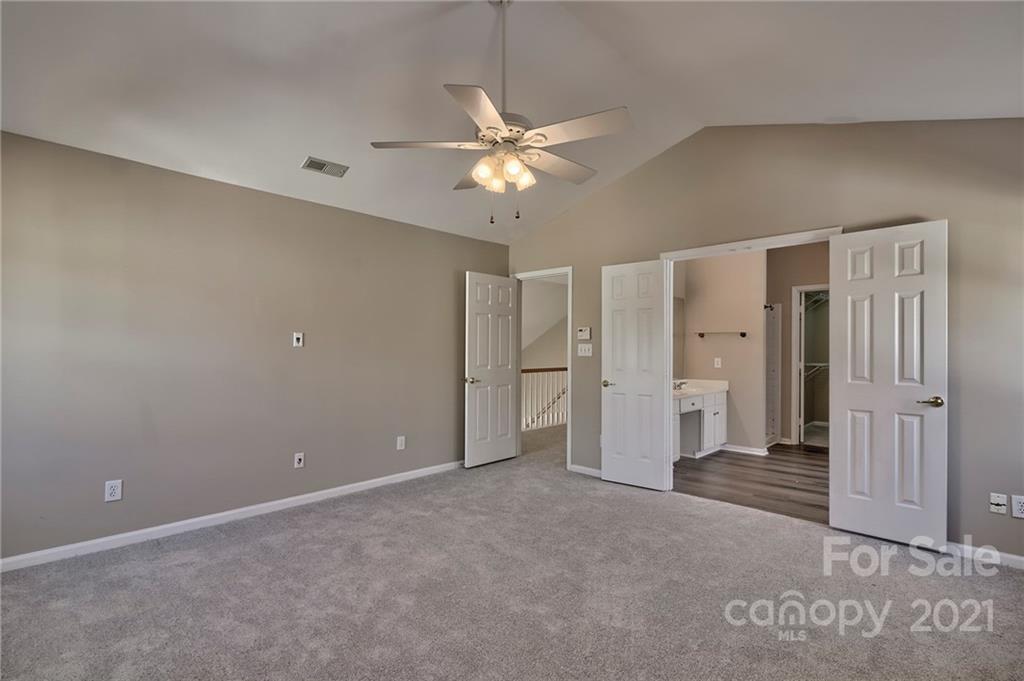 4821 Brownes Ferry Road Charlotte, NC 28269 - Photo 30 of 37 a view of a livingroom with a ceiling fan & entryway