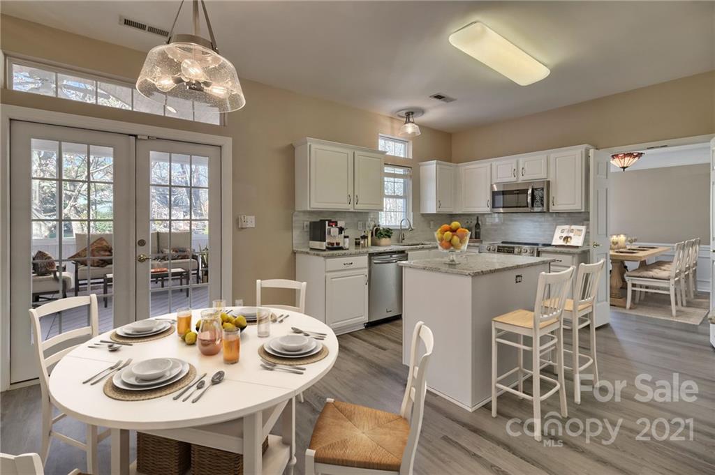 4821 Brownes Ferry Road Charlotte, NC 28269 - Photo 3 of 37 a kitchen with granite countertop stainless steel appliances a dining table and chairs