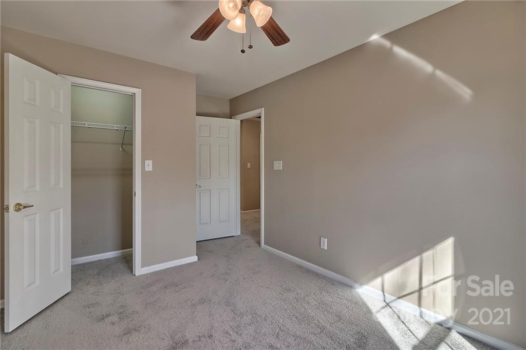 4821 Brownes Ferry Road Charlotte, NC 28269 - Photo 32 of 37 a view of an empty room with a ceiling fan