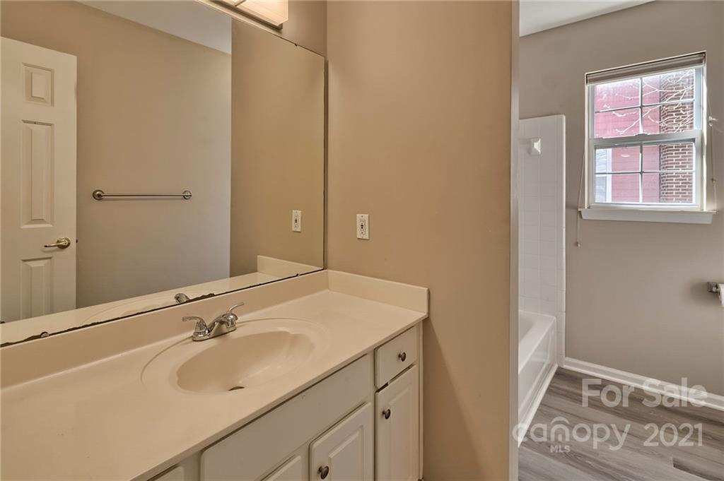 4821 Brownes Ferry Road Charlotte, NC 28269 - Photo 33 of 37 a bathroom with a sink and a mirror