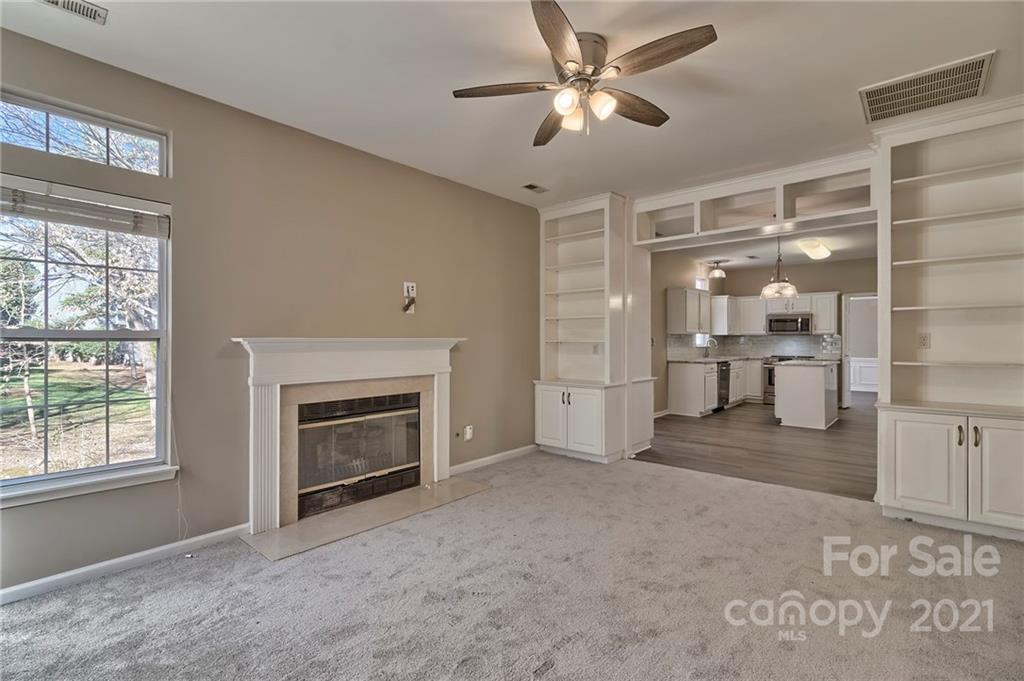 4821 Brownes Ferry Road Charlotte, NC 28269 - Photo 9 of 37 a view of an empty room with a fireplace and a window