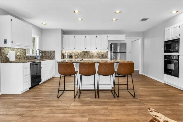 a view of kitchen with cabinets table and chairs