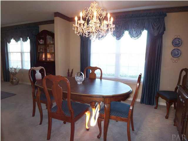5730 Frank Reeder Road Pensacola, FL 32526 - Photo 4 of 24 Formal dining room. All custom drapes and blinds will stay. Chandelier also will stay.