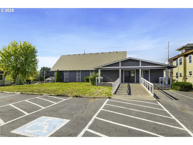 a view of a big building with yard and entertaining space