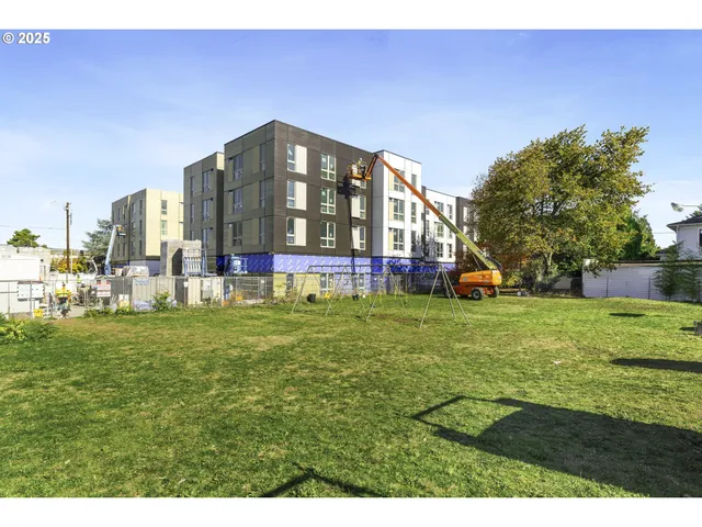 a view of a street with a building in the background