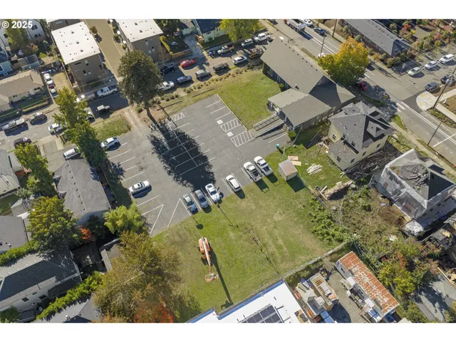 an aerial view of residential building with parking