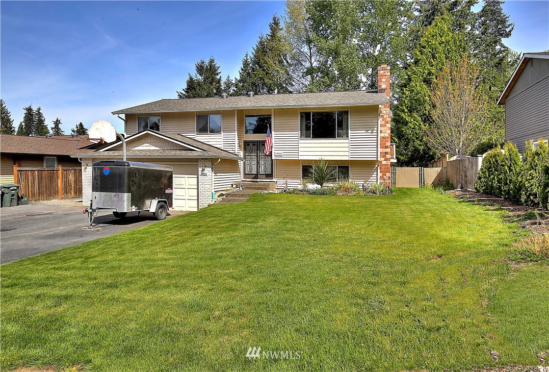 10020 Northeast 204th Street Bothell, WA 98011 - Photo 1 of 30 a front view of a house with a yard table and chairs