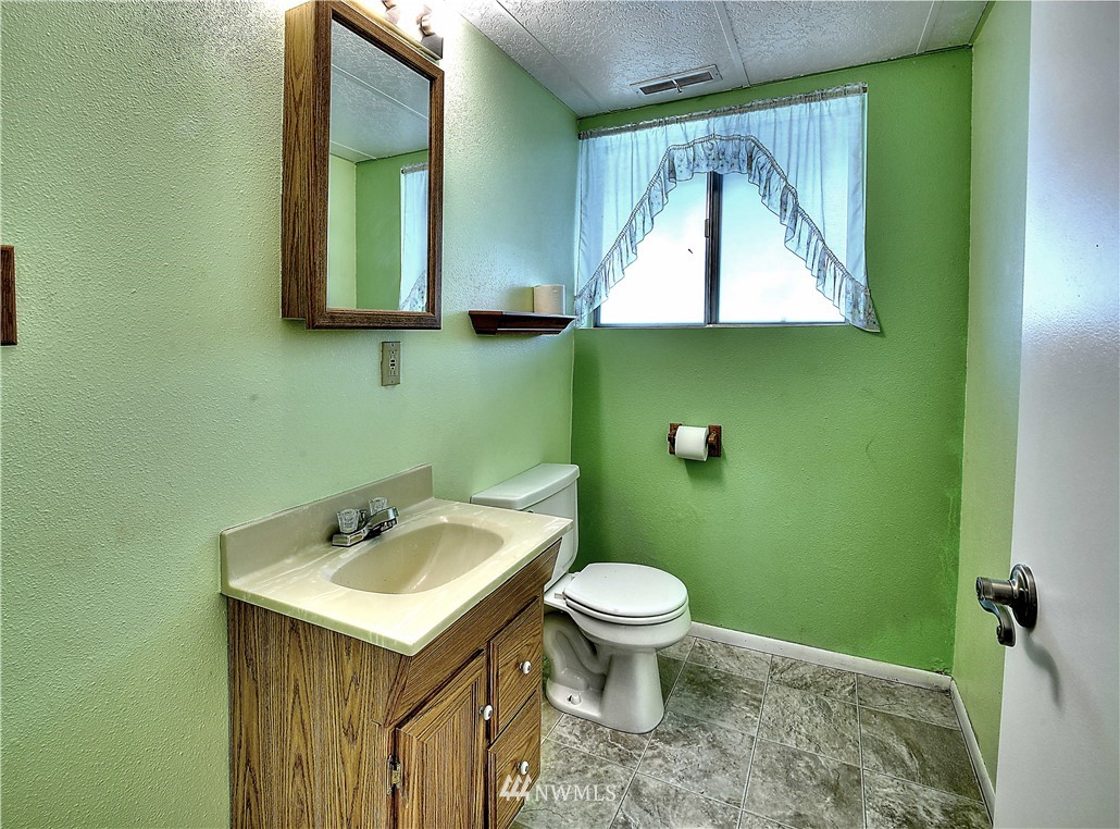 10020 Northeast 204th Street Bothell, WA 98011 - Photo 18 of 30 a bathroom with a sink and a mirror