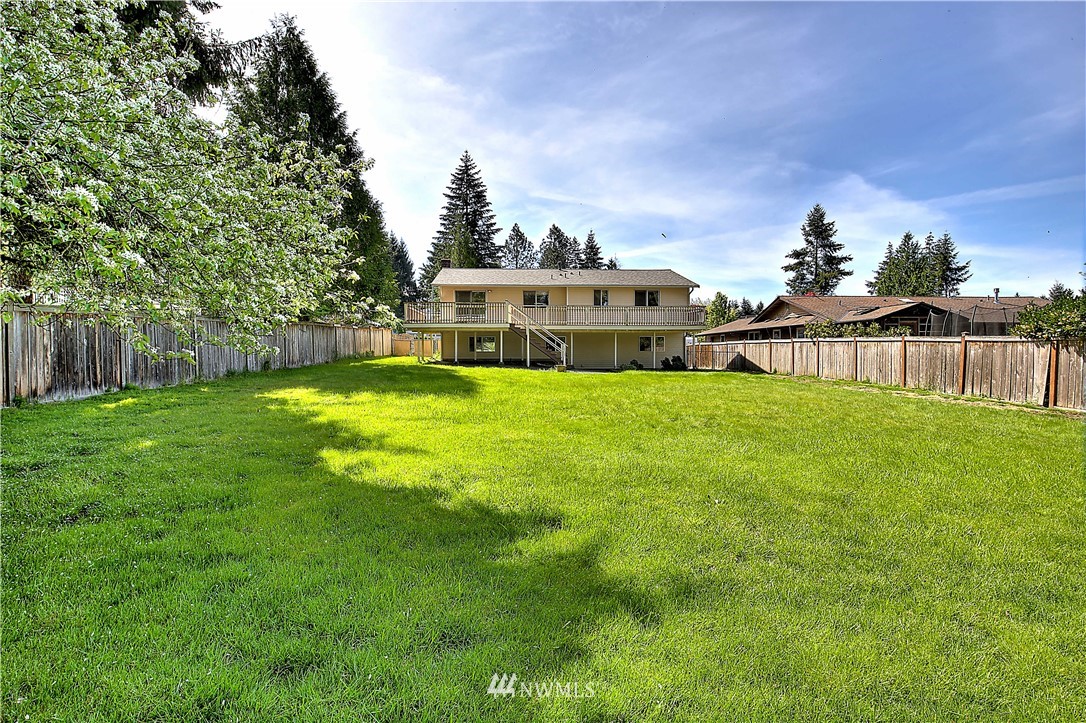 10020 Northeast 204th Street Bothell, WA 98011 - Photo 26 of 30 a view of a house with a big yard and large trees