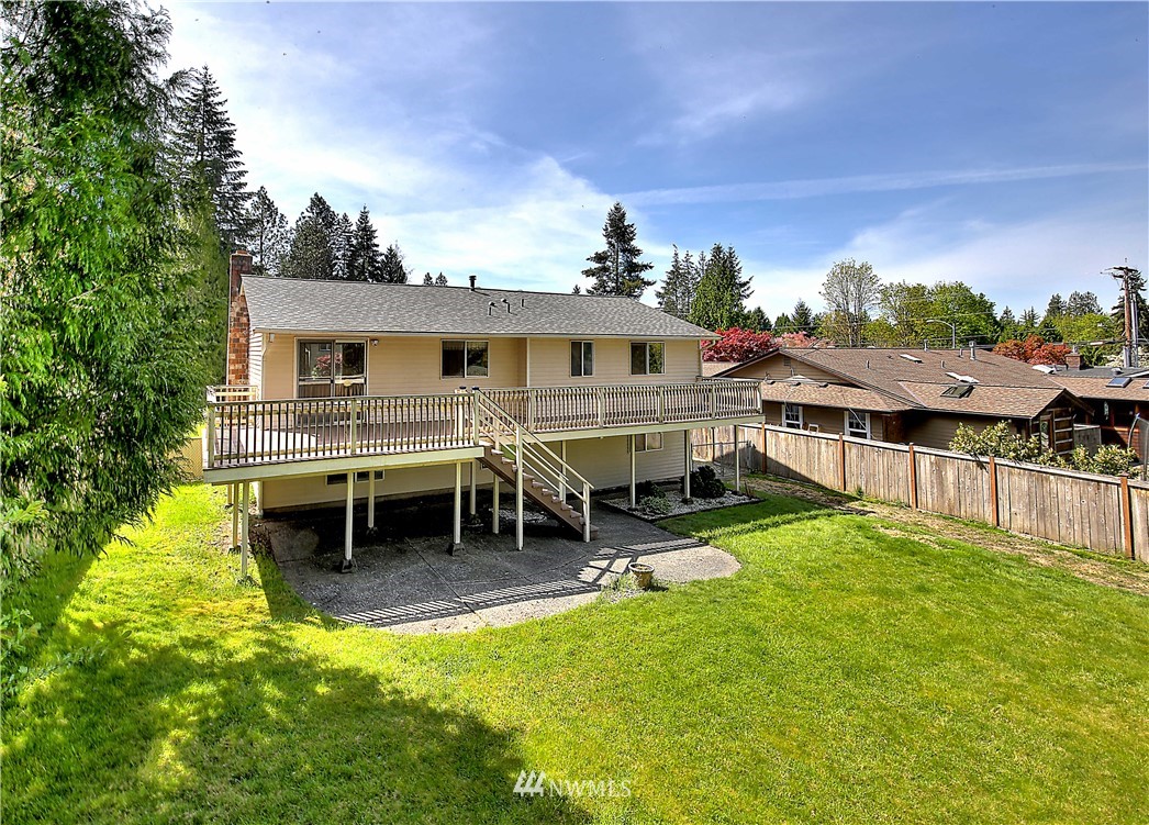 10020 Northeast 204th Street Bothell, WA 98011 - Photo 28 of 30 a view of a house with a wooden deck and a big yard