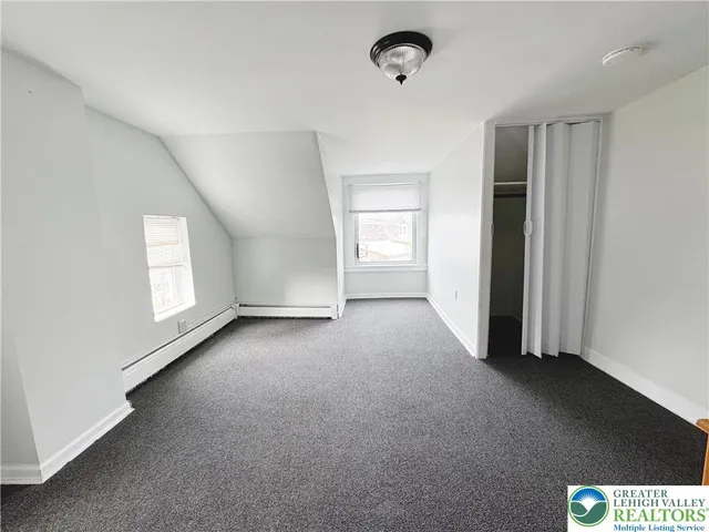 an empty room with a empty space and windows