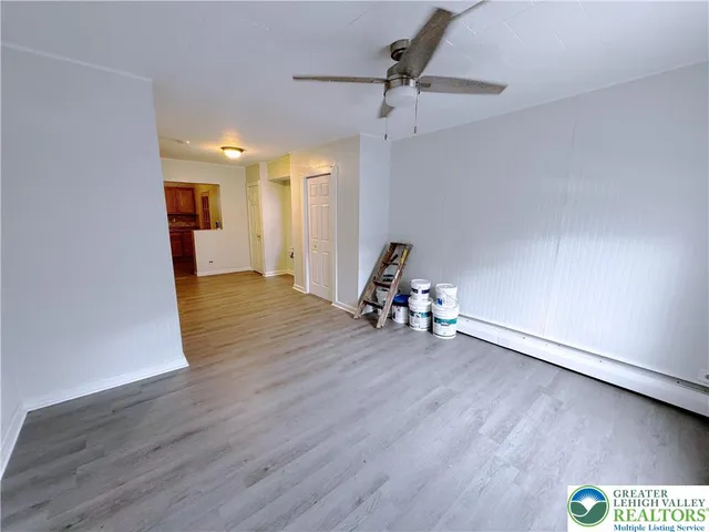 a view of a room with wooden floor and gym equipment