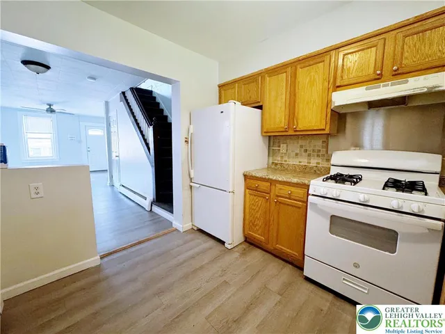 a kitchen with a stove sink and a refrigerator