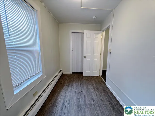 a view of a room with wooden floor
