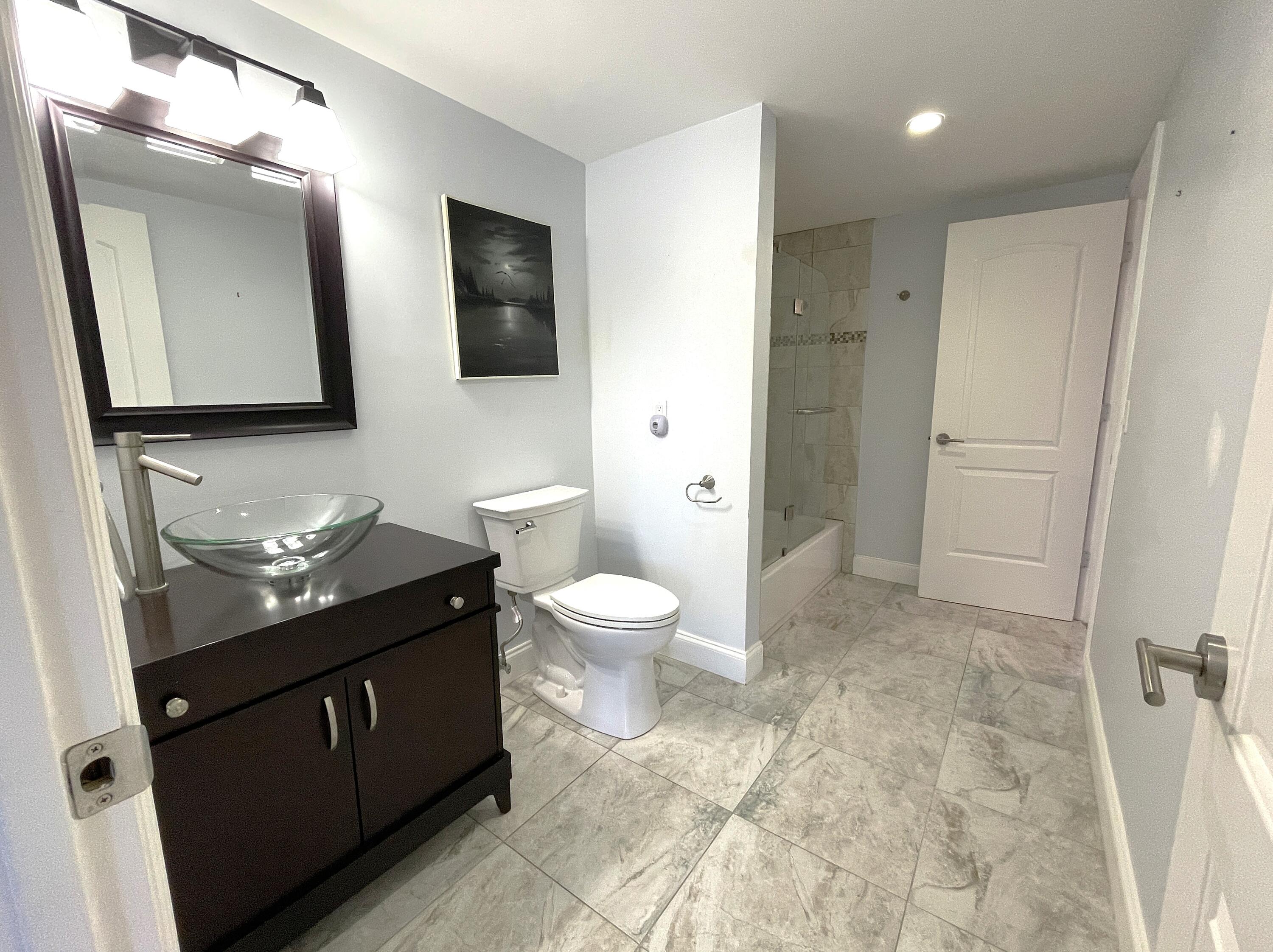 3 Royal Palm Way, Unit 2050 Boca Raton, FL 33432 - Photo 12 of 25 a bathroom with a toilet sink double vanity and mirror