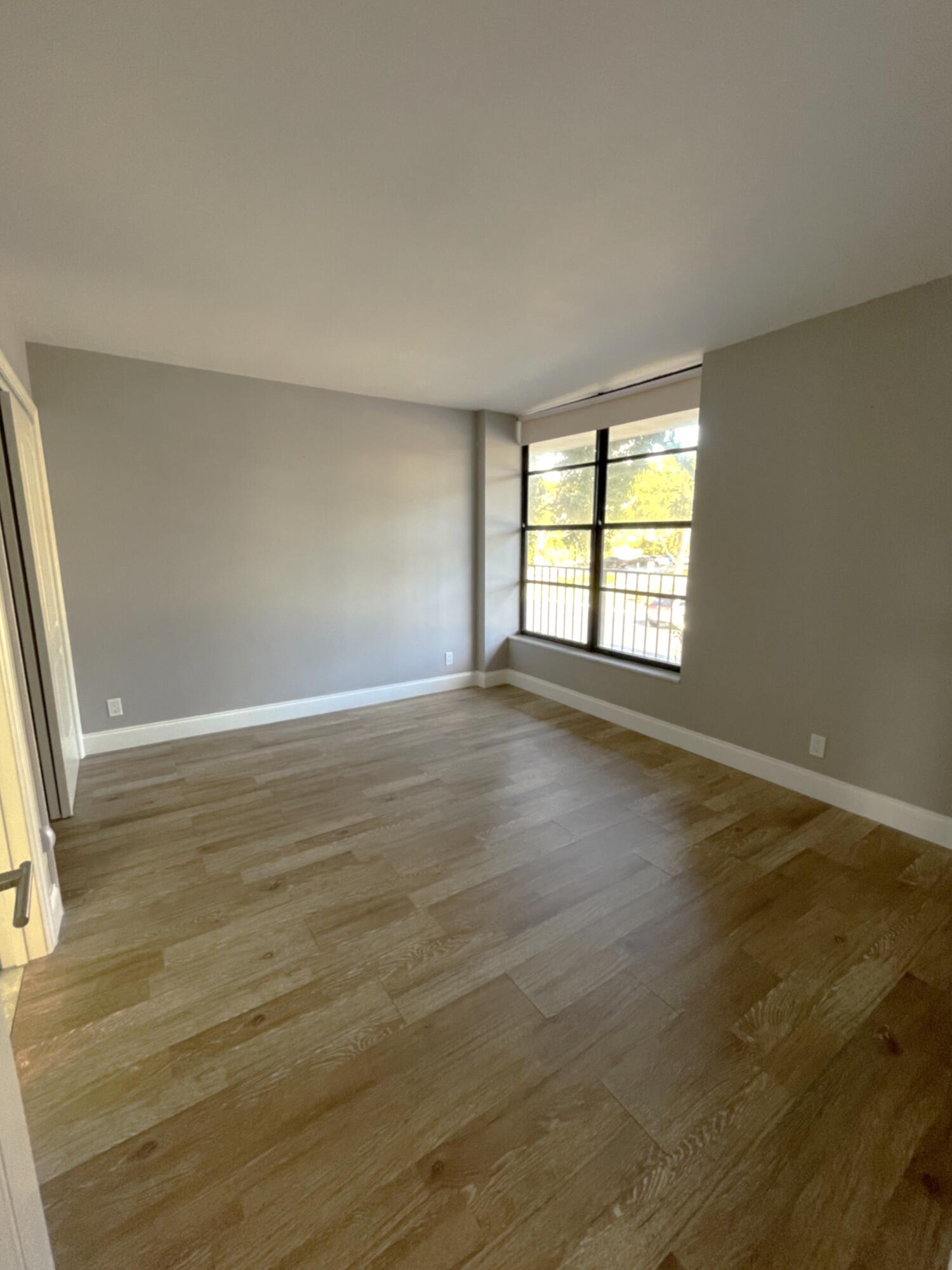 3 Royal Palm Way, Unit 2050 Boca Raton, FL 33432 - Photo 16 of 25 an empty room with wooden floor and windows