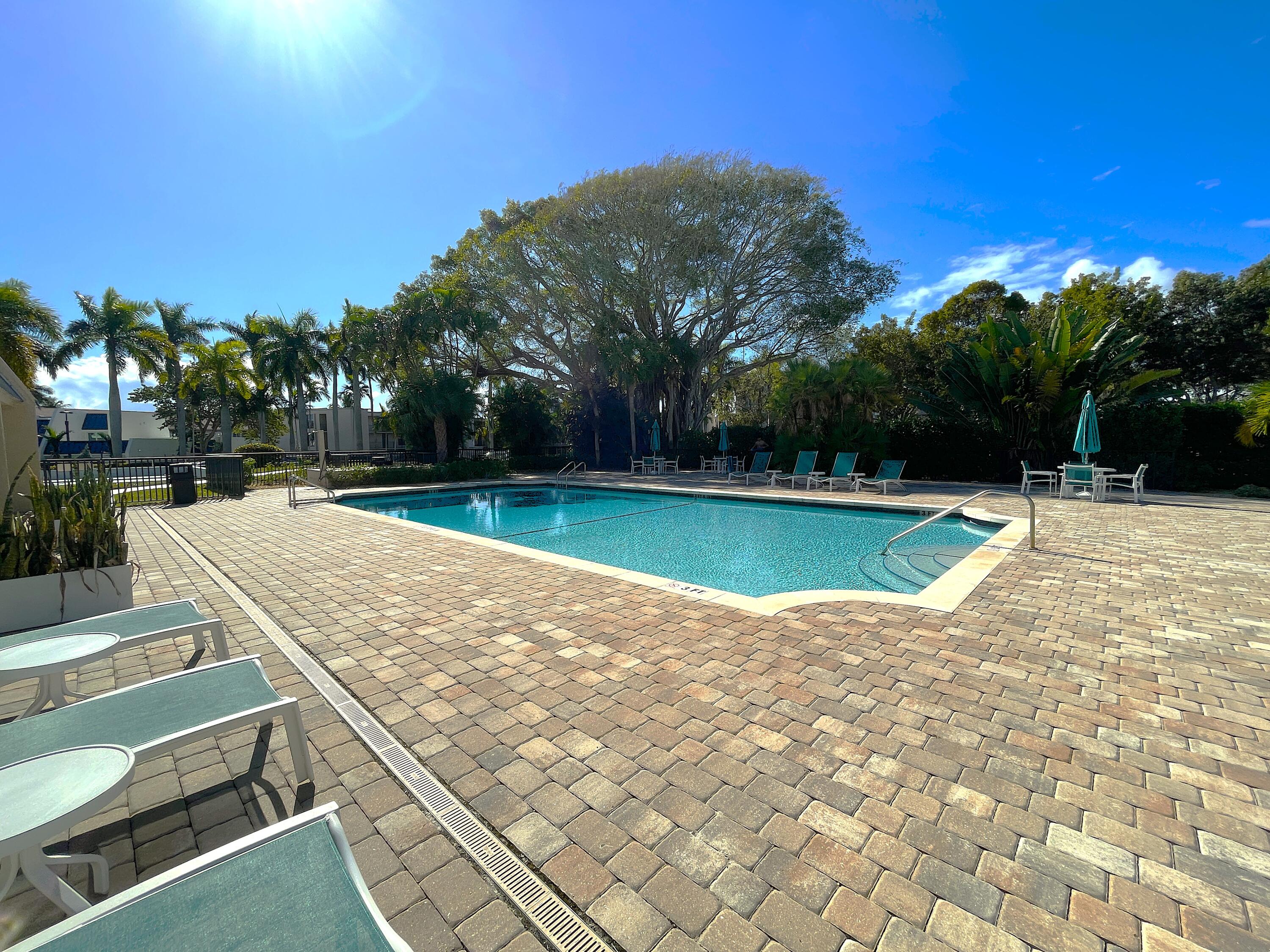 3 Royal Palm Way, Unit 2050 Boca Raton, FL 33432 - Photo 20 of 25 a view of a swimming pool with an outdoor space and seating area