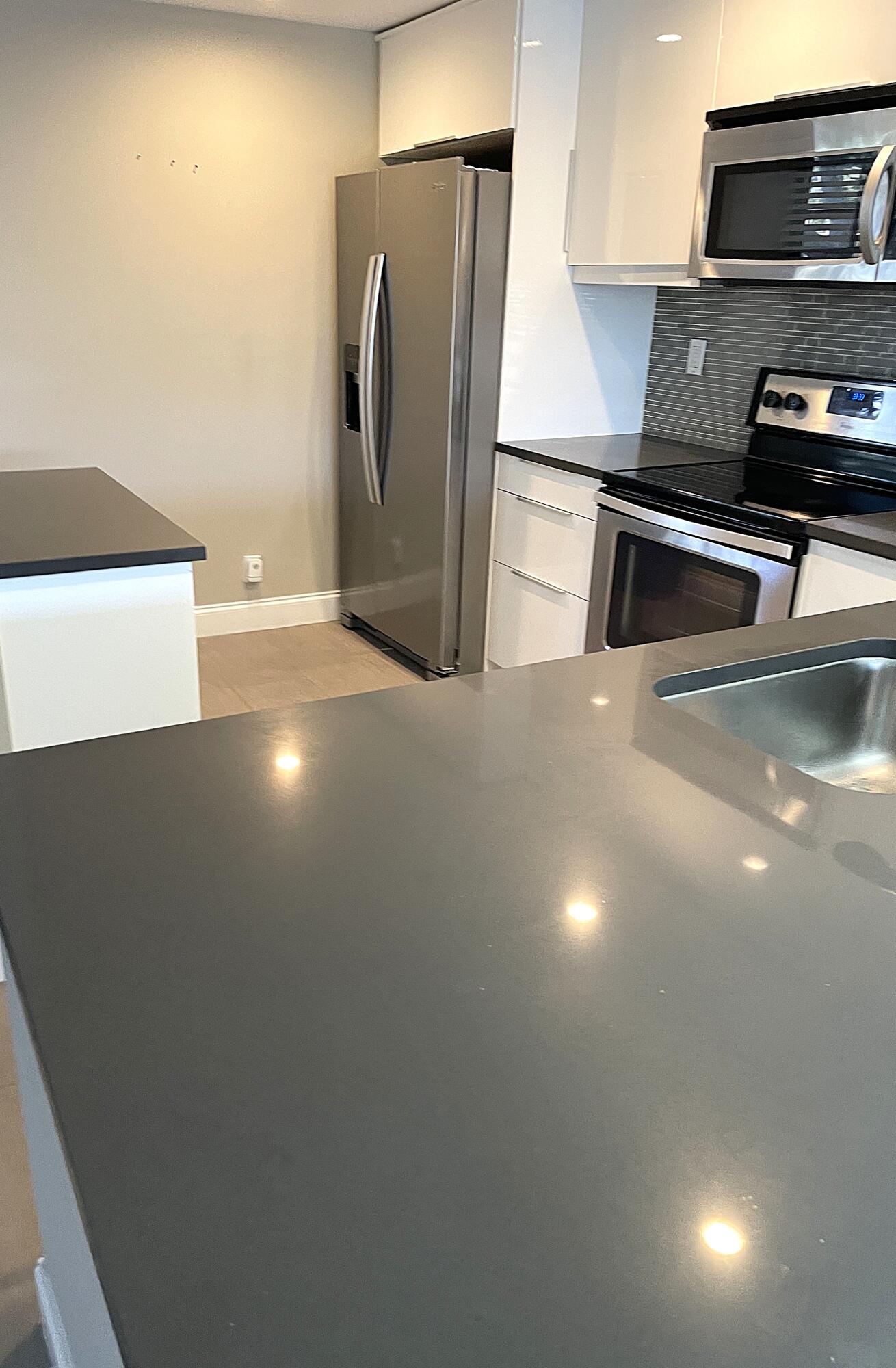 3 Royal Palm Way, Unit 2050 Boca Raton, FL 33432 - Photo 7 of 25 a view of a refrigerator a sink and an oven in a room