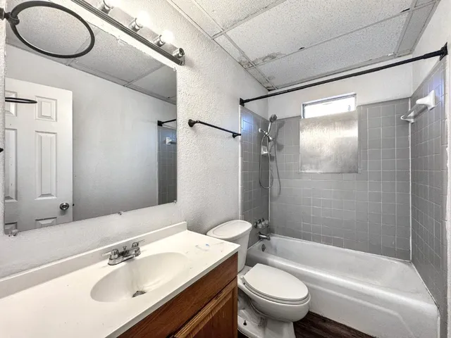 a bathroom with a sink toilet tub and shower