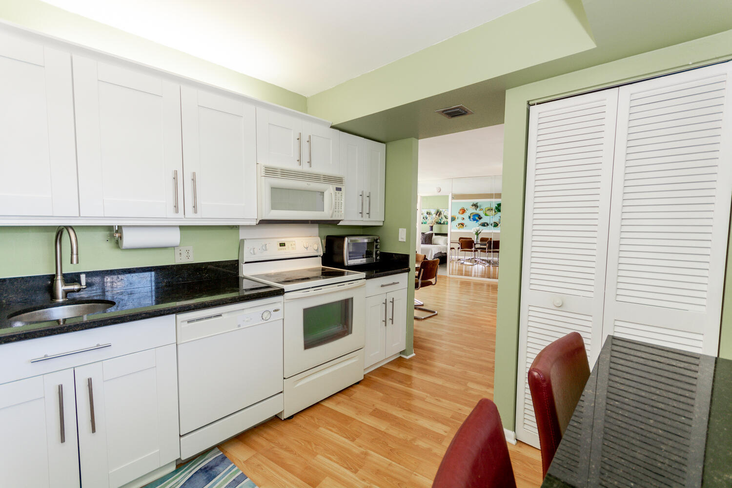 400 Ocean Trail Way, Unit 1405 Jupiter, FL 33477 - Photo 13 of 41 a kitchen with granite countertop a sink a stove and cabinets