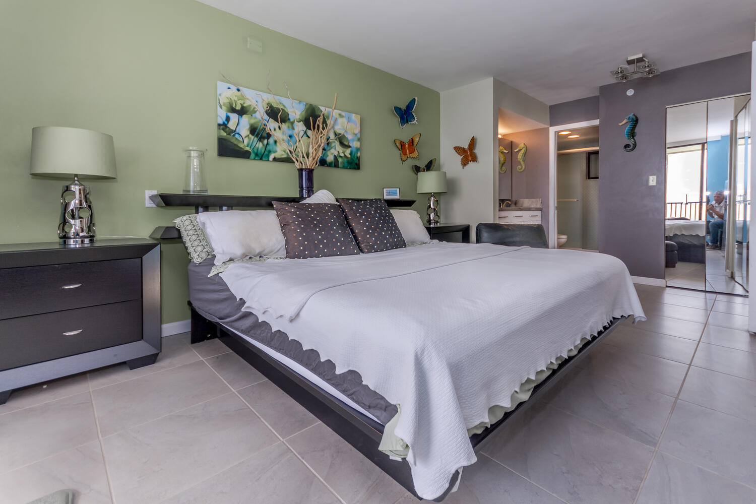 400 Ocean Trail Way, Unit 1405 Jupiter, FL 33477 - Photo 18 of 41 a spacious bedroom with a bed and a lamp on dresser