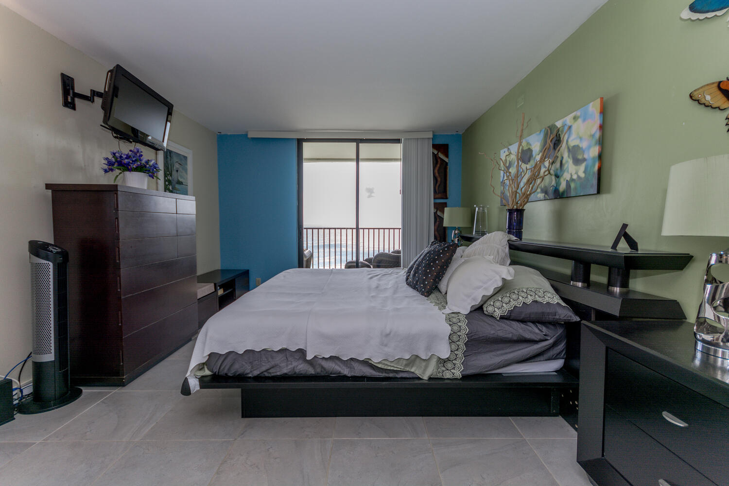 400 Ocean Trail Way, Unit 1405 Jupiter, FL 33477 - Photo 19 of 41 a bedroom with a bed and wooden floor