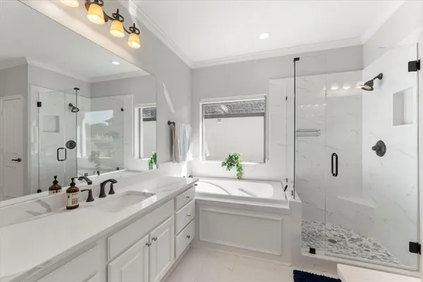 a bathroom with a granite countertop sink mirror and shower