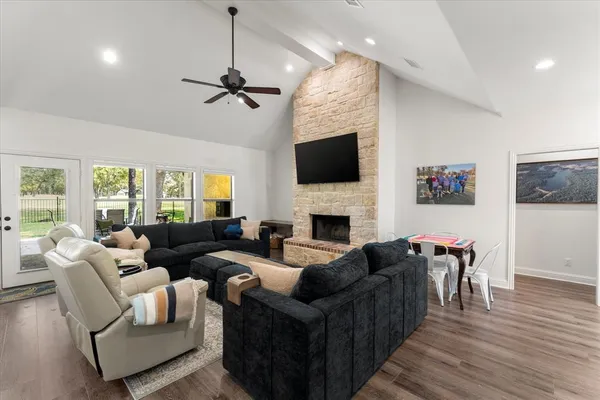 a living room with furniture a fireplace and a flat screen tv
