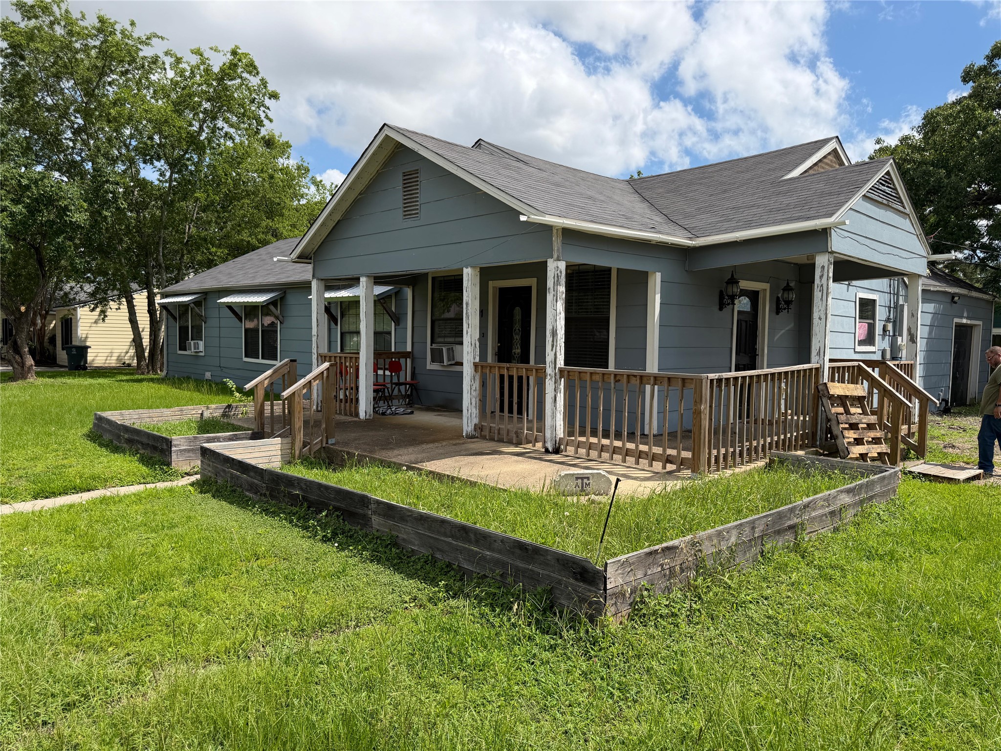 A welcoming front porch with wooden railings frames this charming residence.