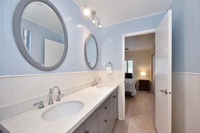 a view of a house with a small yard plants and large tree