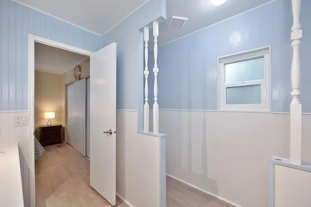 a front view of a house with a garden and plants