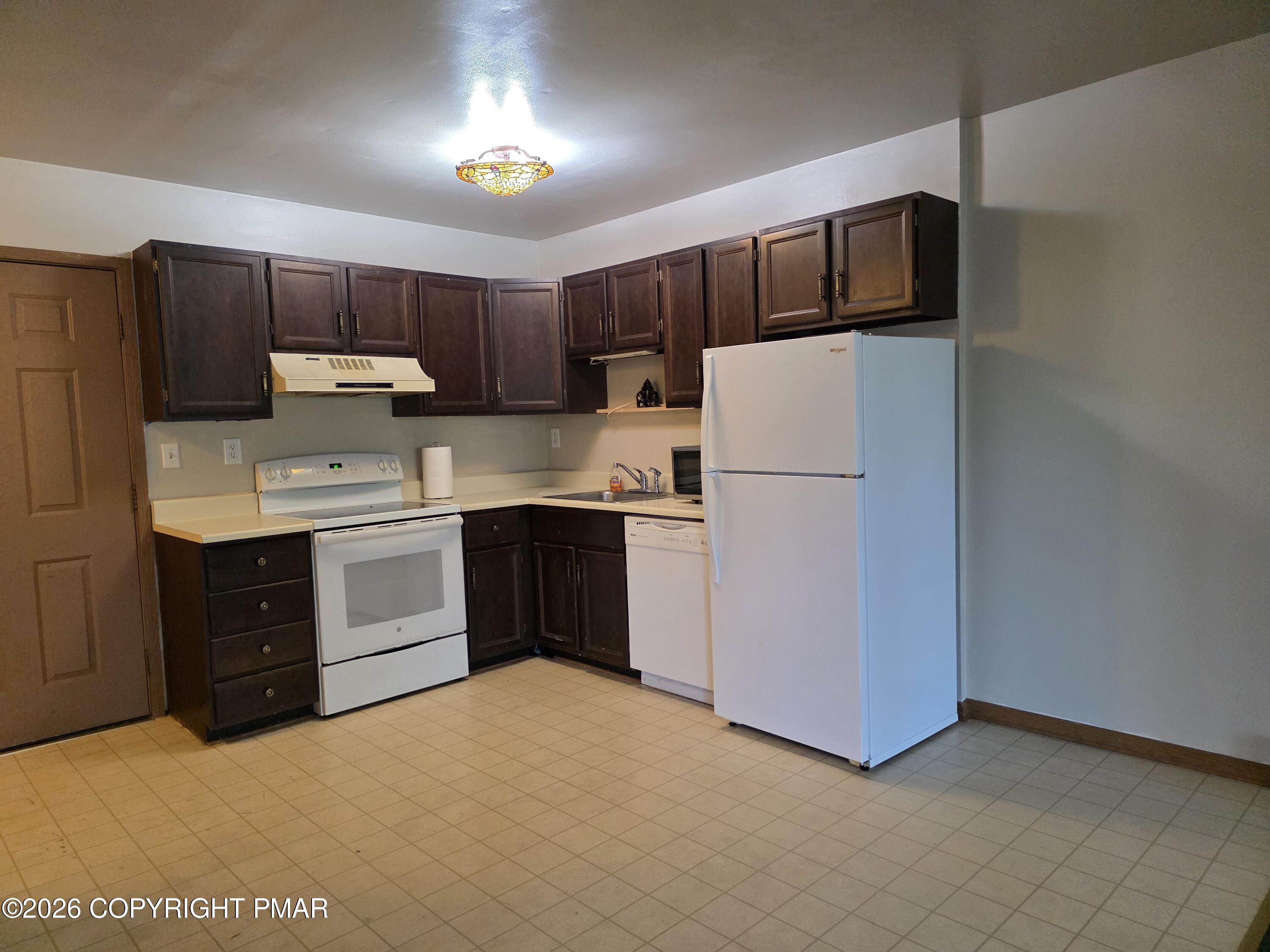 317 Keswick Avenue Bushkill, PA 18324 - Photo 4 of 21 a kitchen with kitchen island a white cabinets and refrigerator