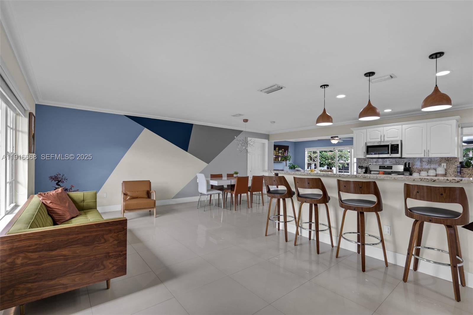 a living room with lots of furniture and kitchen view