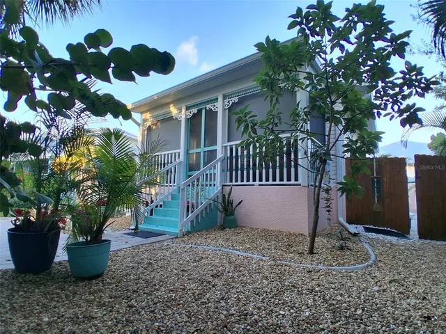 a view of a patio with table and chairs under an umbrella