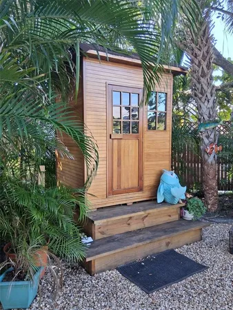 a kitchen with stainless steel appliances granite countertop a refrigerator a stove a sink dishwasher and a dining table with wooden floor