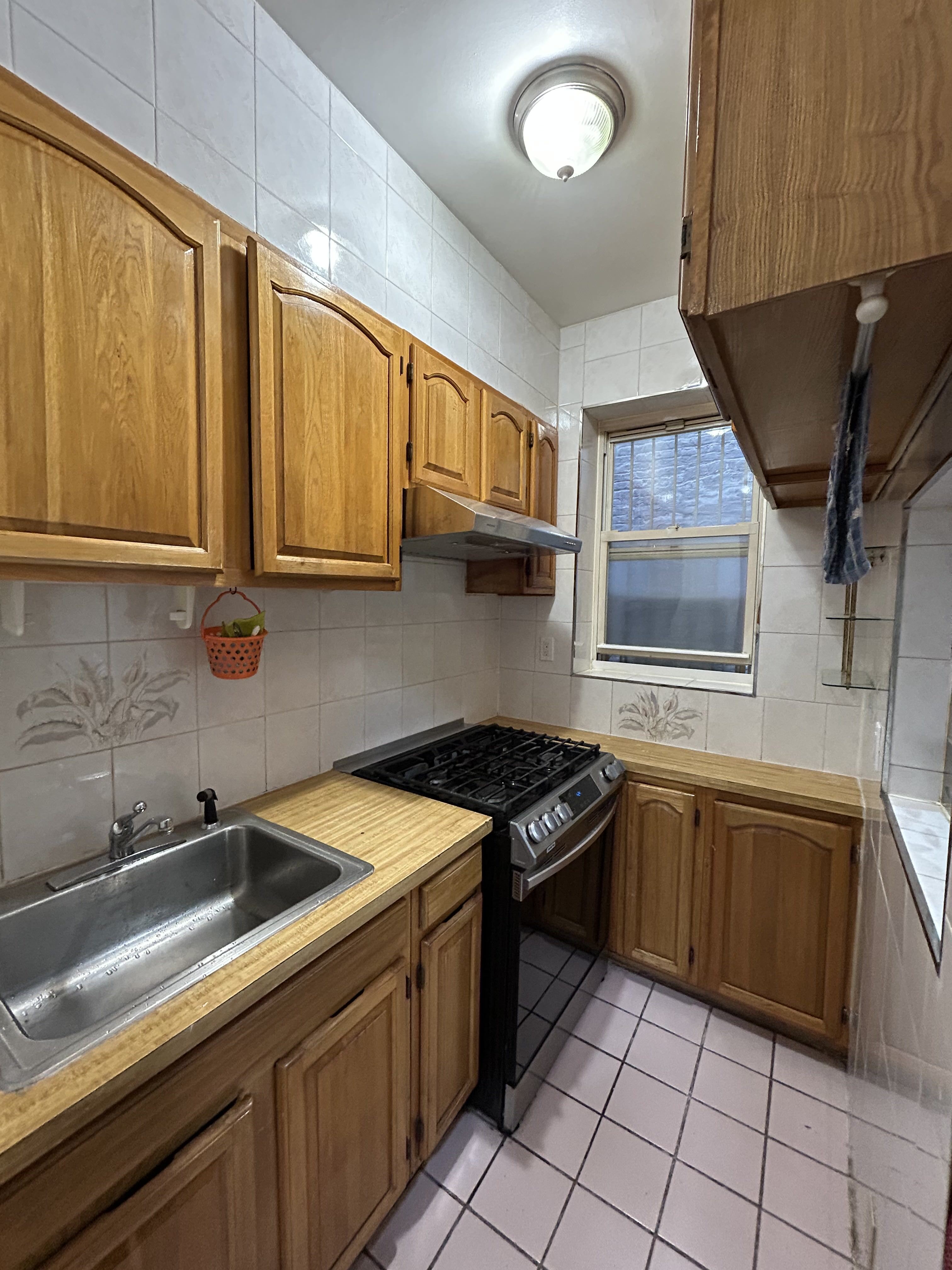 839 53rd Street, Unit 1 Brooklyn, NY 11220 - Photo 2 of 10 a kitchen that has a sink and a stove