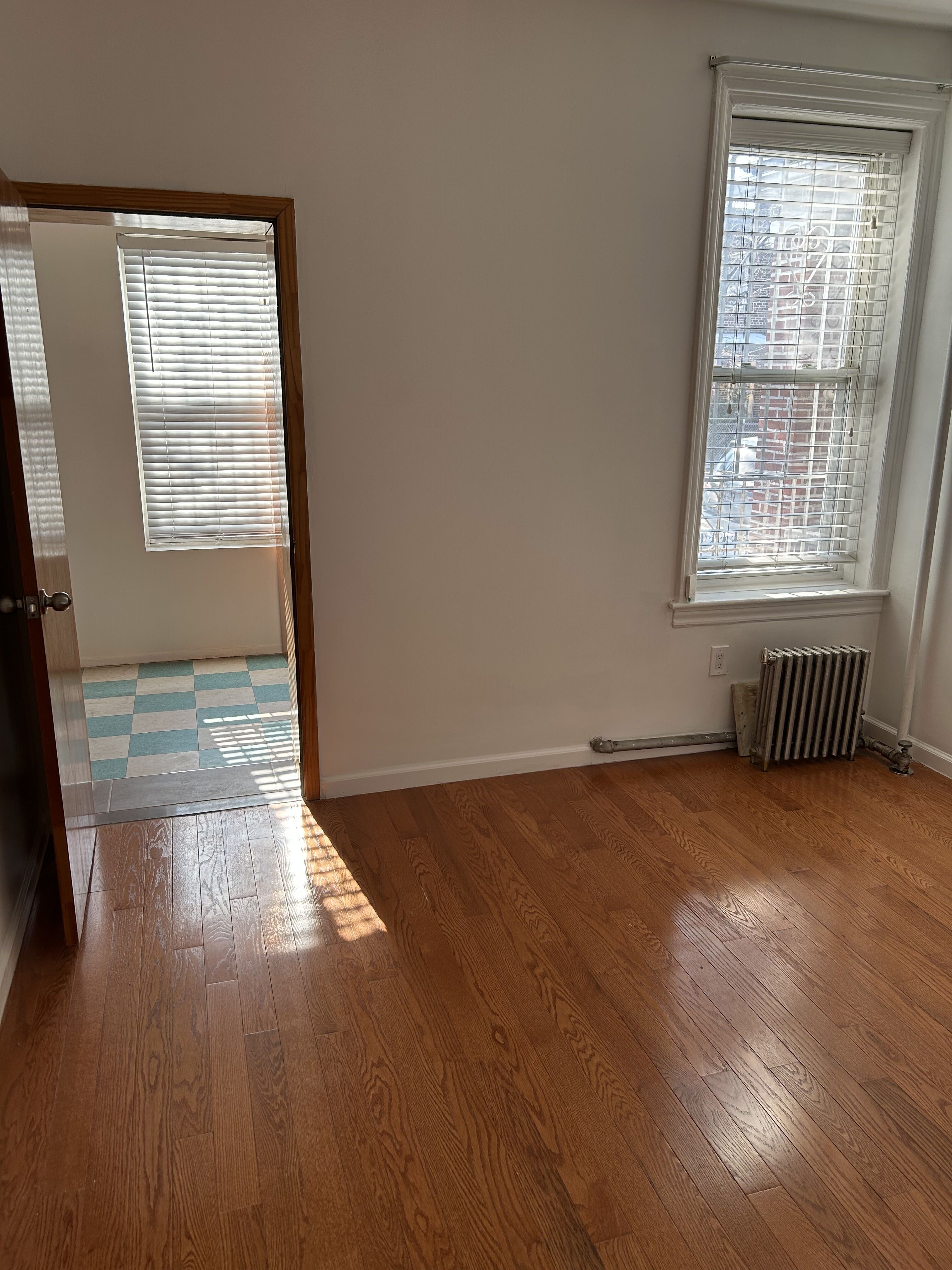 839 53rd Street, Unit 1 Brooklyn, NY 11220 - Photo 9 of 10 an empty room with wooden floor and windows