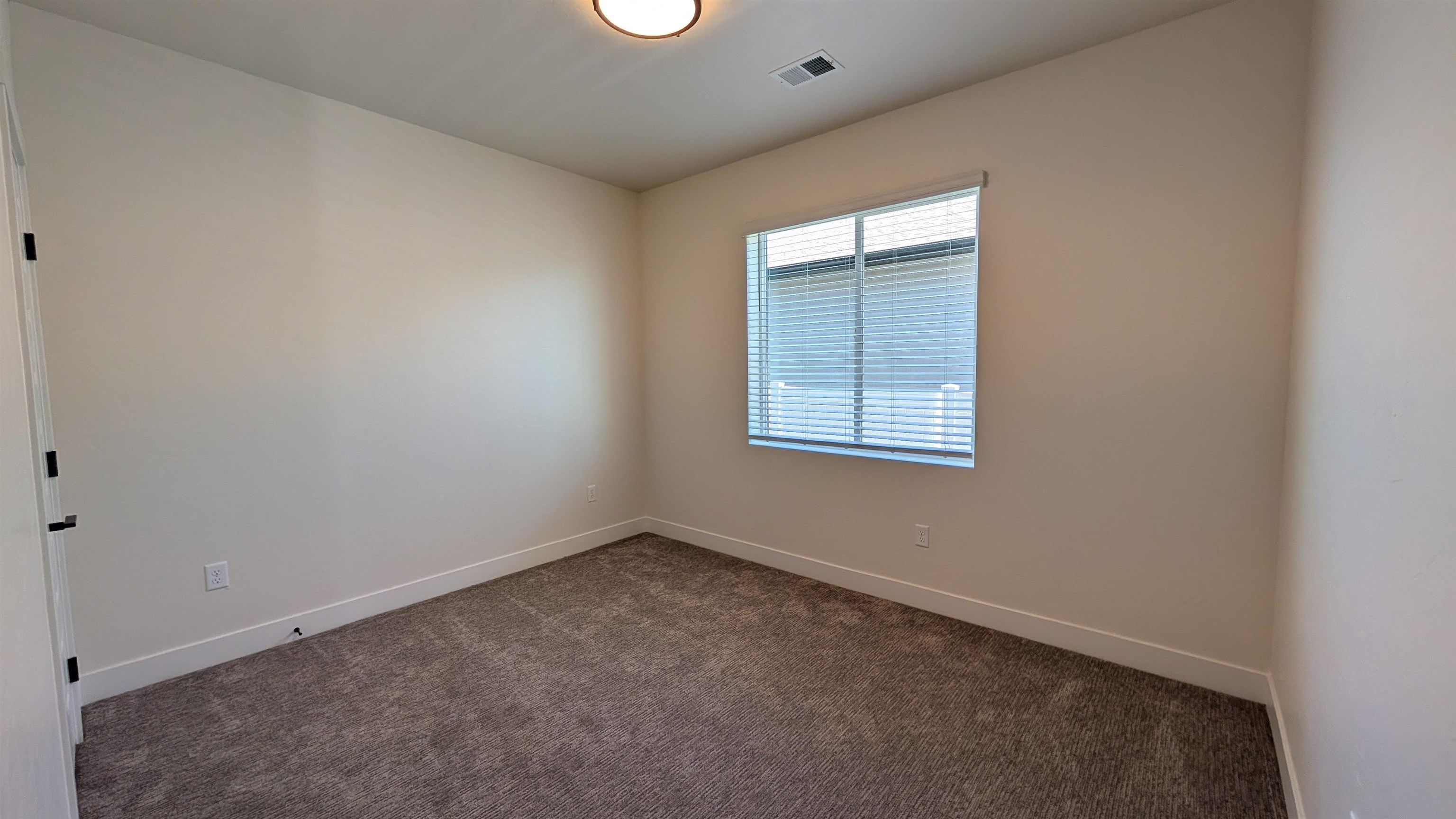 1660 Rusty Rivet Road Fruita, CO 81521 - Photo 7 of 15 an empty room with a window