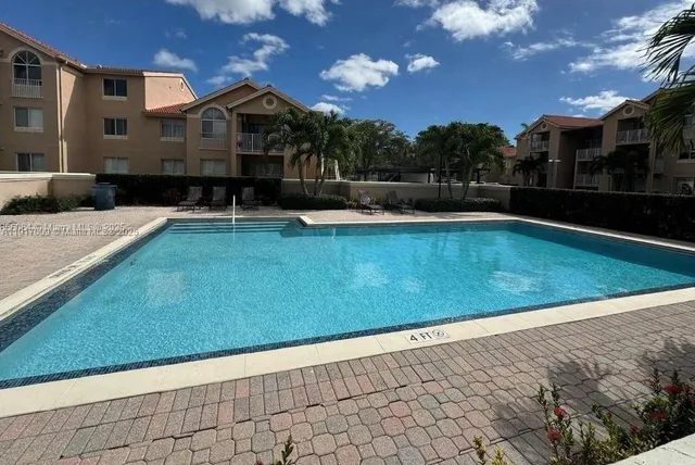a view of a swimming pool with a yard