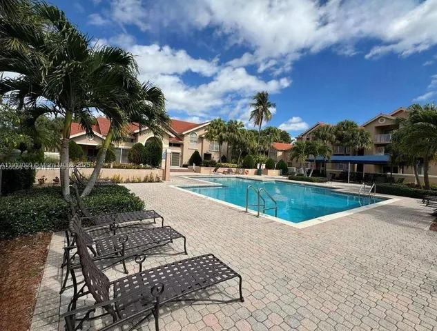 a view of a swimming pool with a yard