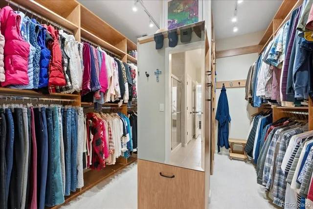 a view of walk in closet with clothes
