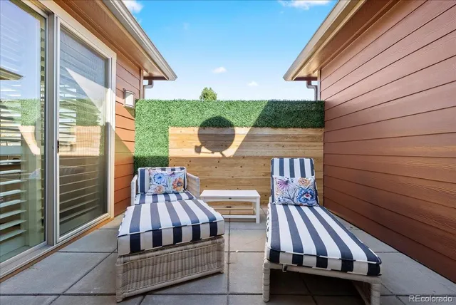 a view of balcony with two chairs and a barbeque
