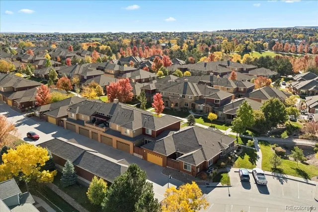 an aerial view of a house with a garden and lake view
